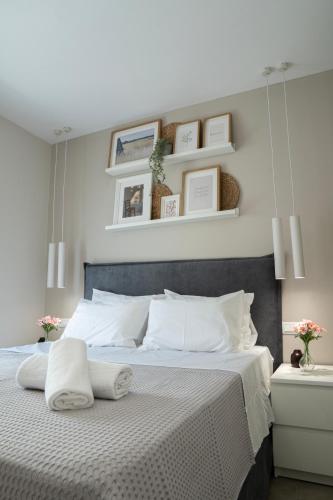 a bedroom with a large bed with two white pillows at Armonía Luxury Apartments in Ierapetra