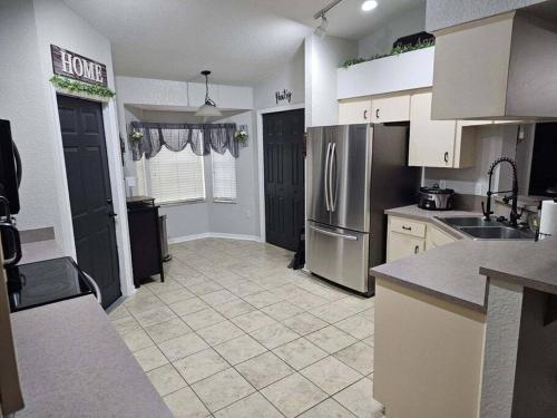 a kitchen with a sink and a refrigerator at Timbercrest in Providence