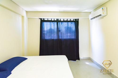 Postel nebo postele na pokoji v ubytování Zaffir Apartamento
