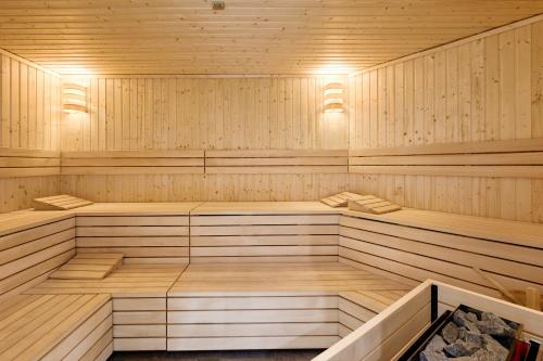an empty sauna with wooden floors and ceilings at Baltic Waves Resort & Wellness I Where the Baltic Meets Luxury in Międzyzdroje