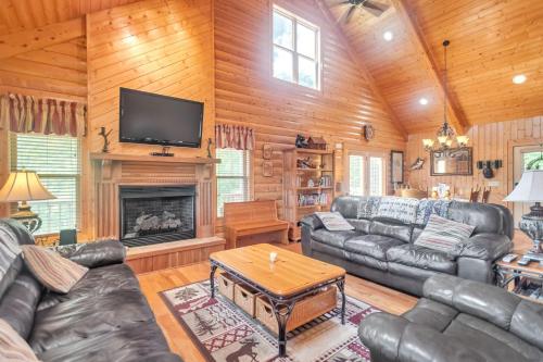 a living room with leather furniture and a fireplace at Cozy Mountain Retreat with Scenic Views home in Beech Mountain