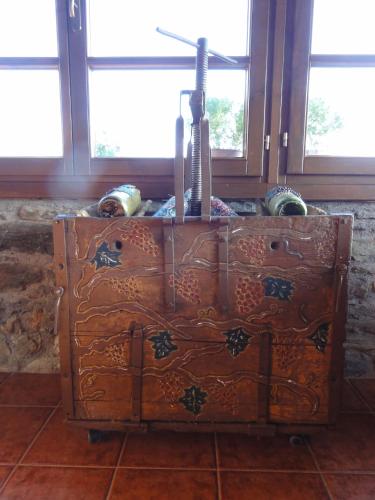 an old wooden chest in a room with windows at Sintrivanis Mountain in Áno Skotína