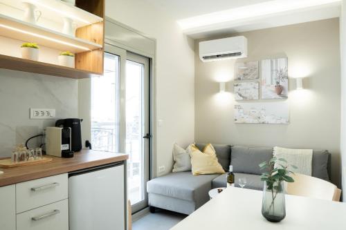 a small living room with a couch and a table at Armonía Luxury Apartments in Ierápetra