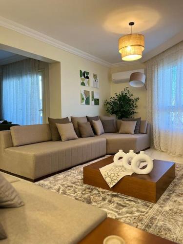 a living room with a couch and a table at Charming apartment In Heliopolis in Cairo