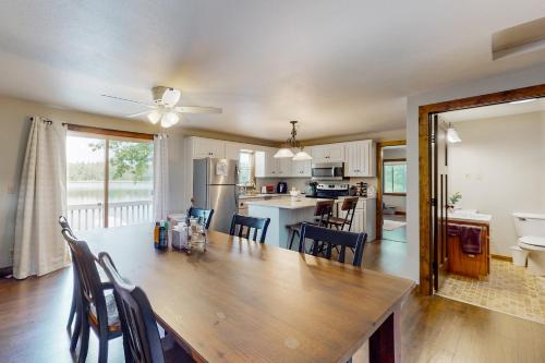 a dining room and kitchen with a table and chairs at Lakeside Solitude in Deerwood