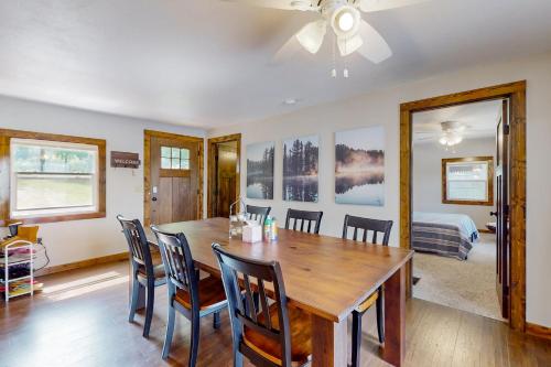 a dining room with a wooden table and chairs at Lakeside Solitude in Deerwood
