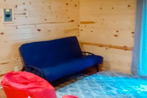 a room with a blue chair and a bed at Lakeside Solitude in Deerwood