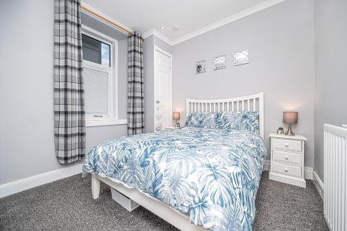 MarkinchにあるThe Wee Haig - 1 Bedroom Condoのベッドルーム(青と白のベッド1台、窓付)