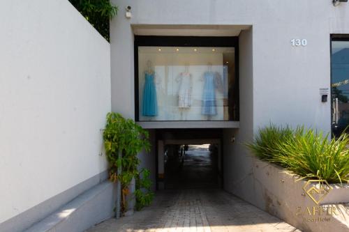 a building with a window with a dress in it at Zaffir Apartamento in Cuiabá