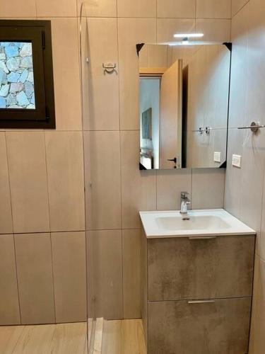 a bathroom with a sink and a mirror at Serenity Blue Las Terrenas in Las Terrenas