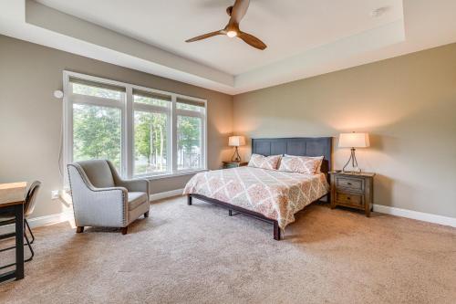 a bedroom with a bed and a chair and a ceiling fan at Lake Anna Home with Dock and Private Shoreline! in Bumpass