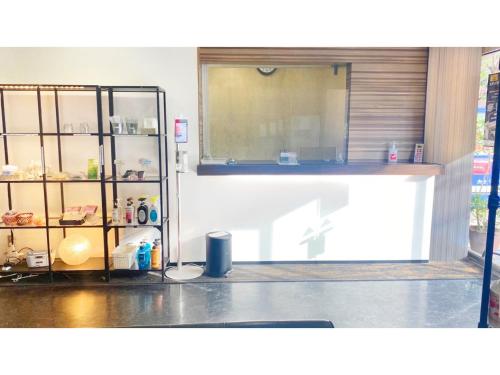 a kitchen with a counter and a glass door at Takatsuki W&M Hotel - Vacation STAY 02641v in Takatuki