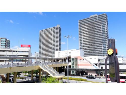 a view of a city with tall buildings and a clock at Takatsuki W&M Hotel - Vacation STAY 02641v in Takatuki