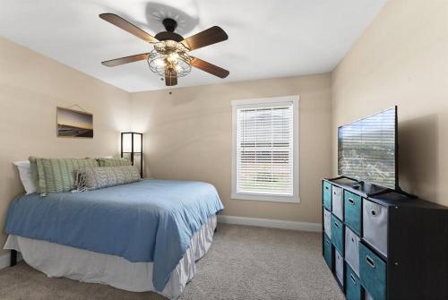 a bedroom with a bed and a ceiling fan at Wander by the Waves Pet Friendly in Palm Coast