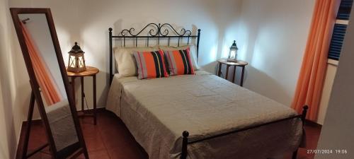 a bedroom with a bed and a mirror and a mirror at Porto Santo Island Ocean Apartment in Vila Baleira