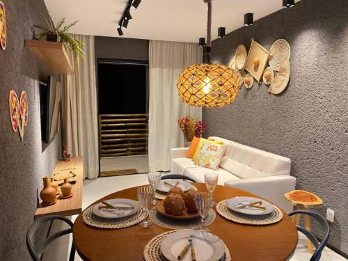 a living room with a table and a couch at Villas Patacho G 102 - Milagres in Pôrto de Pedras