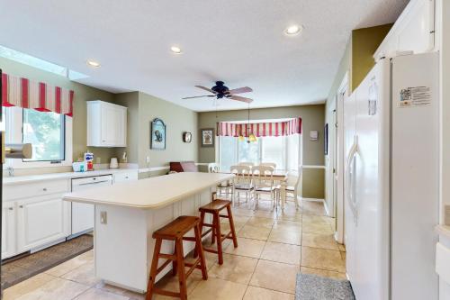 a kitchen with a table and chairs in a room at Eagle Watch in Hilton Head Island