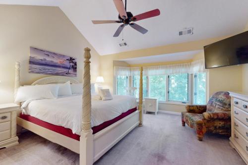 a bedroom with a bed and a ceiling fan at Eagle Watch in Hilton Head Island