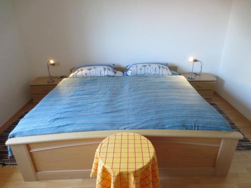 a bedroom with a bed with a blue comforter at Gästehaus Erika in Tengen