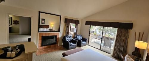 a living room with two chairs and a fireplace at Adobe Inn in Carmel