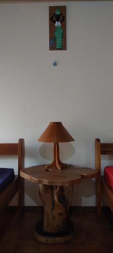 a wooden table with a lamp on top of it at El Castillo Divertido in Paraíso