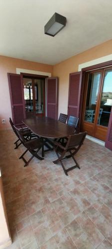 a wooden table and chairs in a room at Villa Giulia in Siracusa