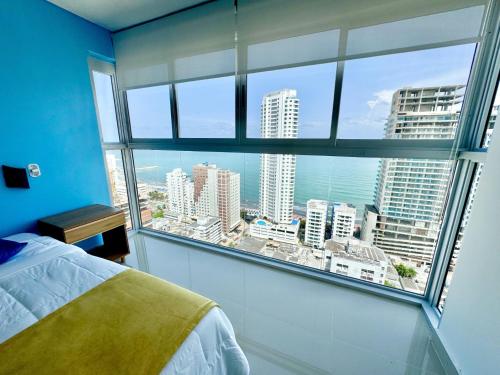 a bedroom with a large window with a view of the city at apto navy 6 tripulantes in Cartagena de Indias
