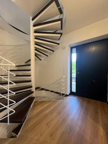 a room with a spiral staircase and a door at Renovierte Doppelhaushälfte in bester Lage in Bottrop