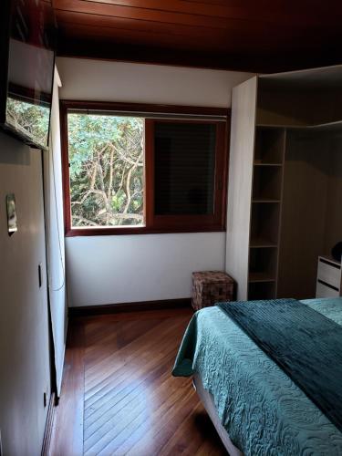 a bedroom with a bed and a large window at Pousada Monte Sião in Sao Paulo