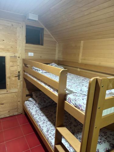 a room with two bunk beds in a cabin at Kamp Vodeni Ćiro in Setihovo