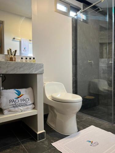 a bathroom with a toilet and a glass shower at Pao Pao Hotel Islas del rosario in Isla Grande