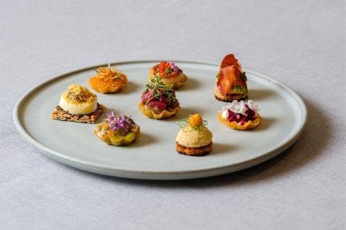 a white plate with many different types of desserts at Sheraton Stockholm Hotel in Stockholm