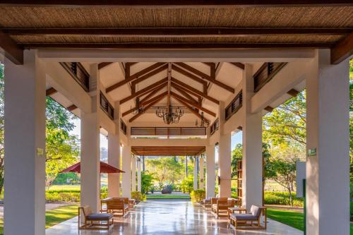 a large pavilion with chairs and a chandelier at Bougainvillea 5102 Luxury Apartment - Reserva Conchal in Playa Conchal