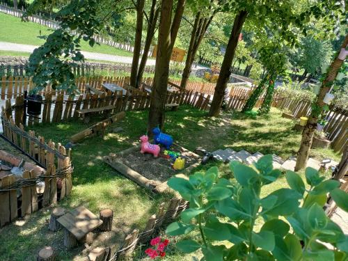 a garden with toys in the grass next to a fence at Konak Lecic in TrÅ¡iÄ‡