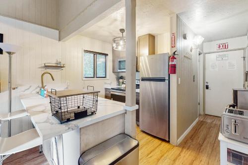 a kitchen with a sink and a refrigerator at Snowy Pines in Fish Camp