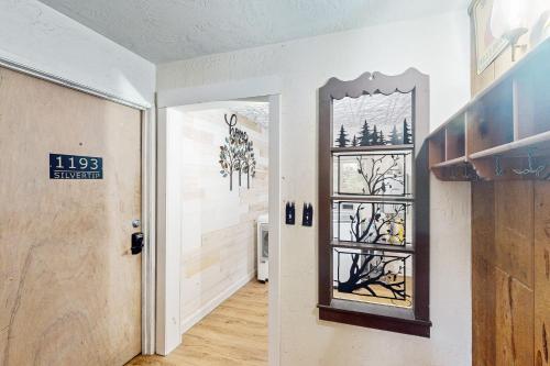 a hallway with a door and a mirror in a room at Snowy Pines in Fish Camp
