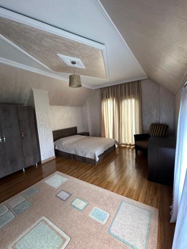 a large bedroom with a bed and a couch at Villa in Tsikhisdziri in Boboqvat'i