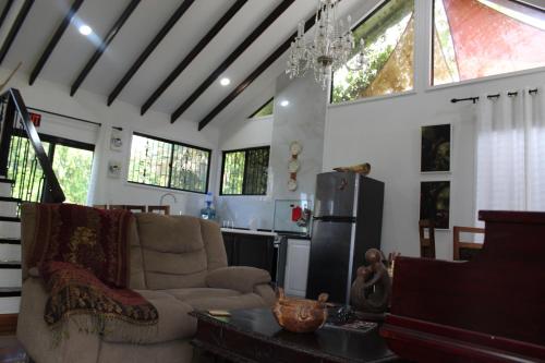 a living room with a couch and a kitchen at CAJOMA Villa 1 in San Ignacio