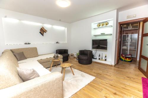 a living room with a couch and a tv at Vukotic in Budva