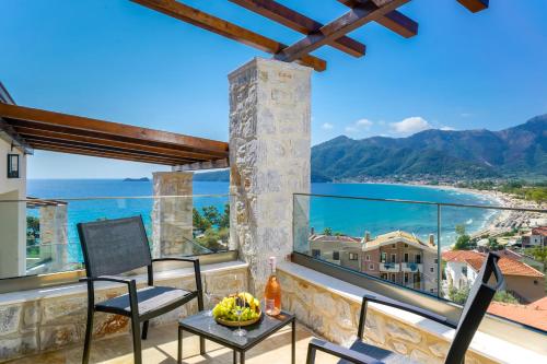 a balcony with a view of the ocean and mountains at Mon Avis Suites in Chrysi Ammoudia