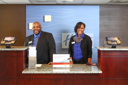 a man and a woman standing at a counter at Holiday Inn Express Hotel & Suites - Atlanta/Emory University Area by IHG in Decatur