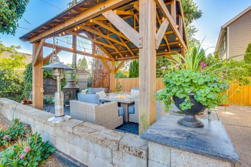 a wooden pergola with a table and chairs at 6 Mi to Autzen Stadium Family Home with Hot Tub! in Eugene