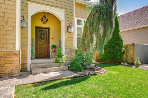 a yellow house with a yellow door and a yard at 6 Mi to Autzen Stadium Family Home with Hot Tub! in Eugene