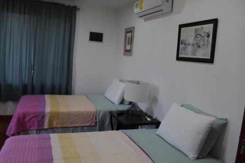 a hotel room with two beds and a window at CAJOMA Villa 1 in San Ignacio