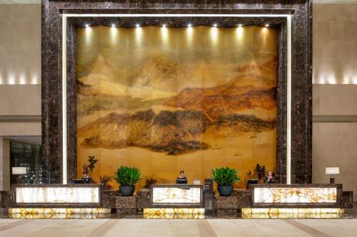 a large painting on a wall in a lobby at Crowne Plaza Yichang by IHG in Yichang