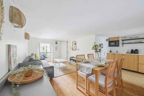 une cuisine et un salon avec une table et des chaises dans l'établissement Super 3 pièces Paris Centre, à Paris