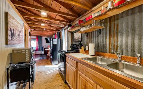 a kitchen with a sink and a stove at Carter`s Charm Cabin in Ruidoso