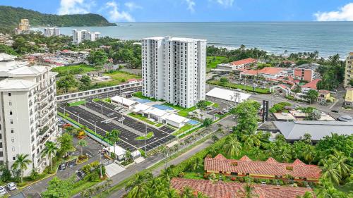 an aerial view of a city with the ocean at Upstay - NEW BUILD - Viva Jaco Condo w Epic Views in Jacó