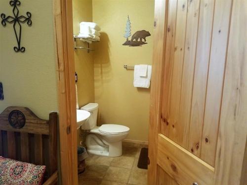 a bathroom with a toilet and a sink at AC - #2 Bear Cabin in Ruidoso