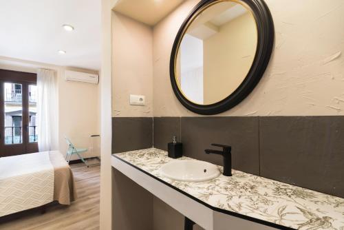 a bathroom with a sink and a mirror on the wall at Hostal Art Madrid in Madrid